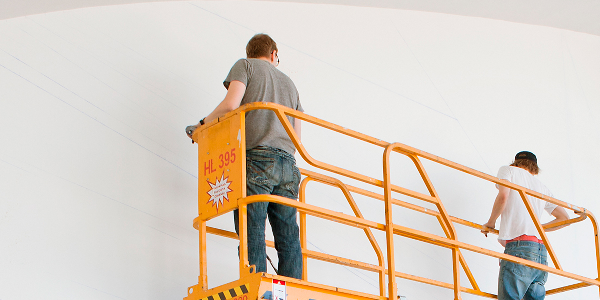 Men painting wall