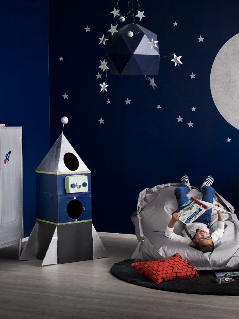 kids room with blue wall and painted with silver moon