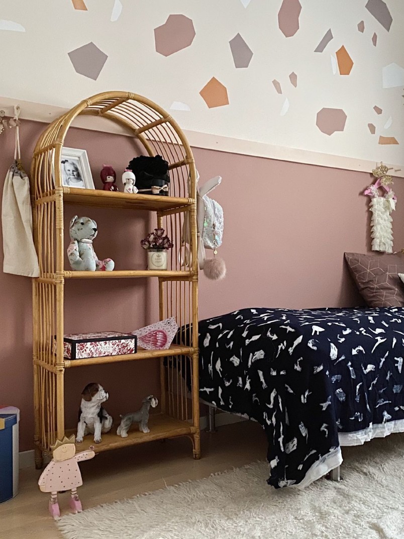 muted pink colour wall in kids room with colourful decorations