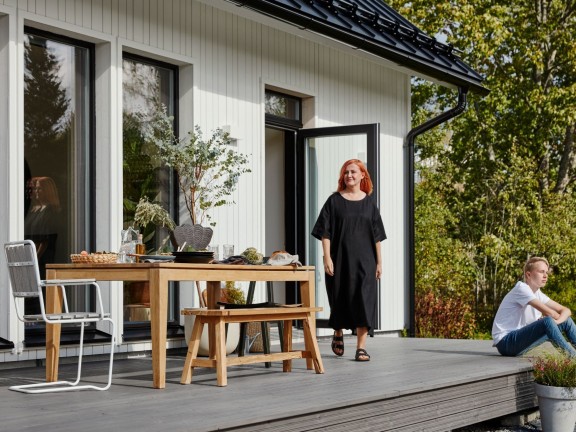white wooden house, woman and son on terrace