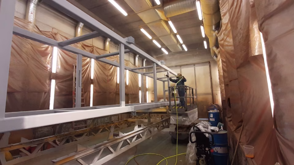 Men painting metal structures