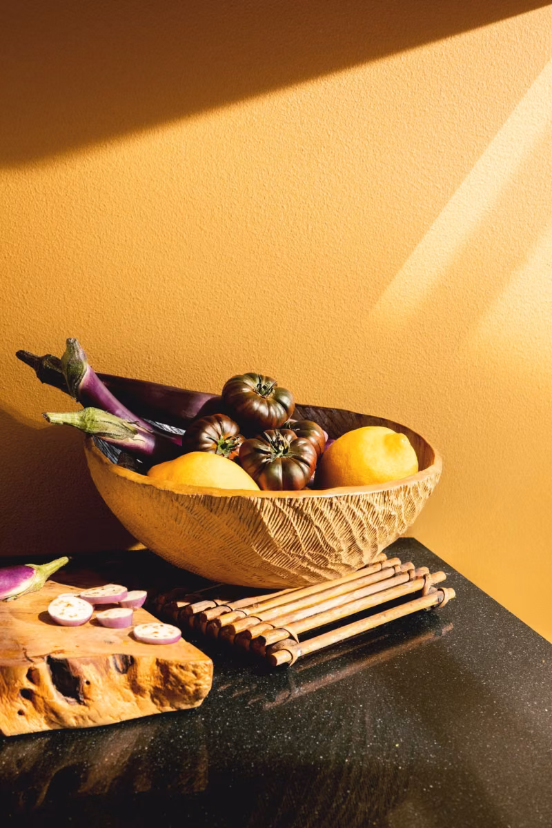 bright yellow wall and dark marble kitchen counter