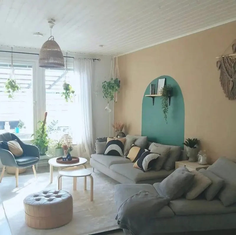 living room wall painted with soft beige and green arc pattern